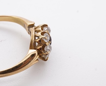 A yellow metal, garnet? and diamond set circular cluster ring (one stone missing), size P, gross weight 3 grams. Condition - poor